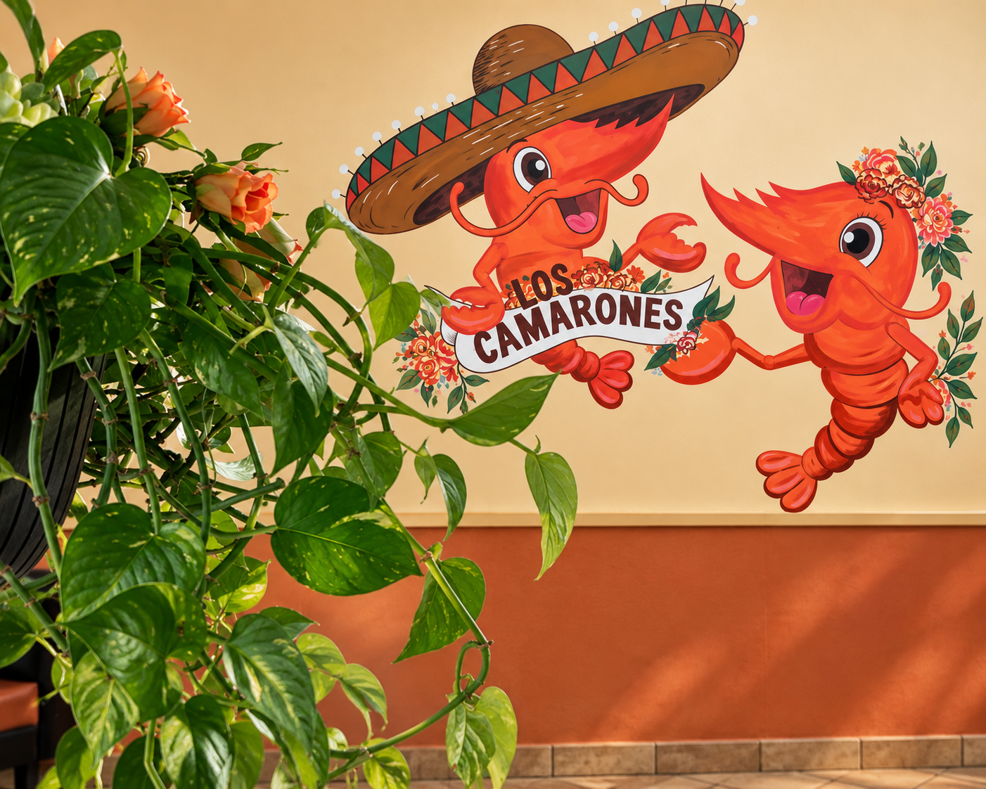Decorative wall mural featuring cartoon crabs, one wearing a sombrero and the other with a floral headband, holding a banner that reads 'Los Camarones' with floral accents.