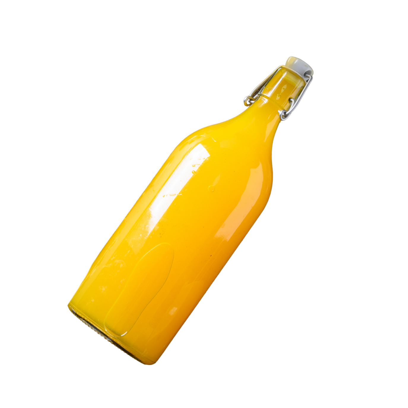 A glass bottle with a swing top closure filled with yellow liquid, likely orange juice, on a black background.