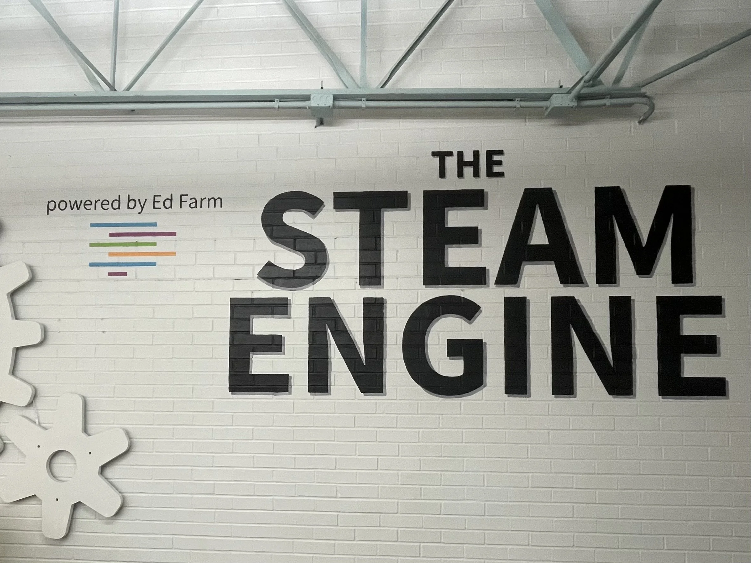 STEAM signage on brick in school library