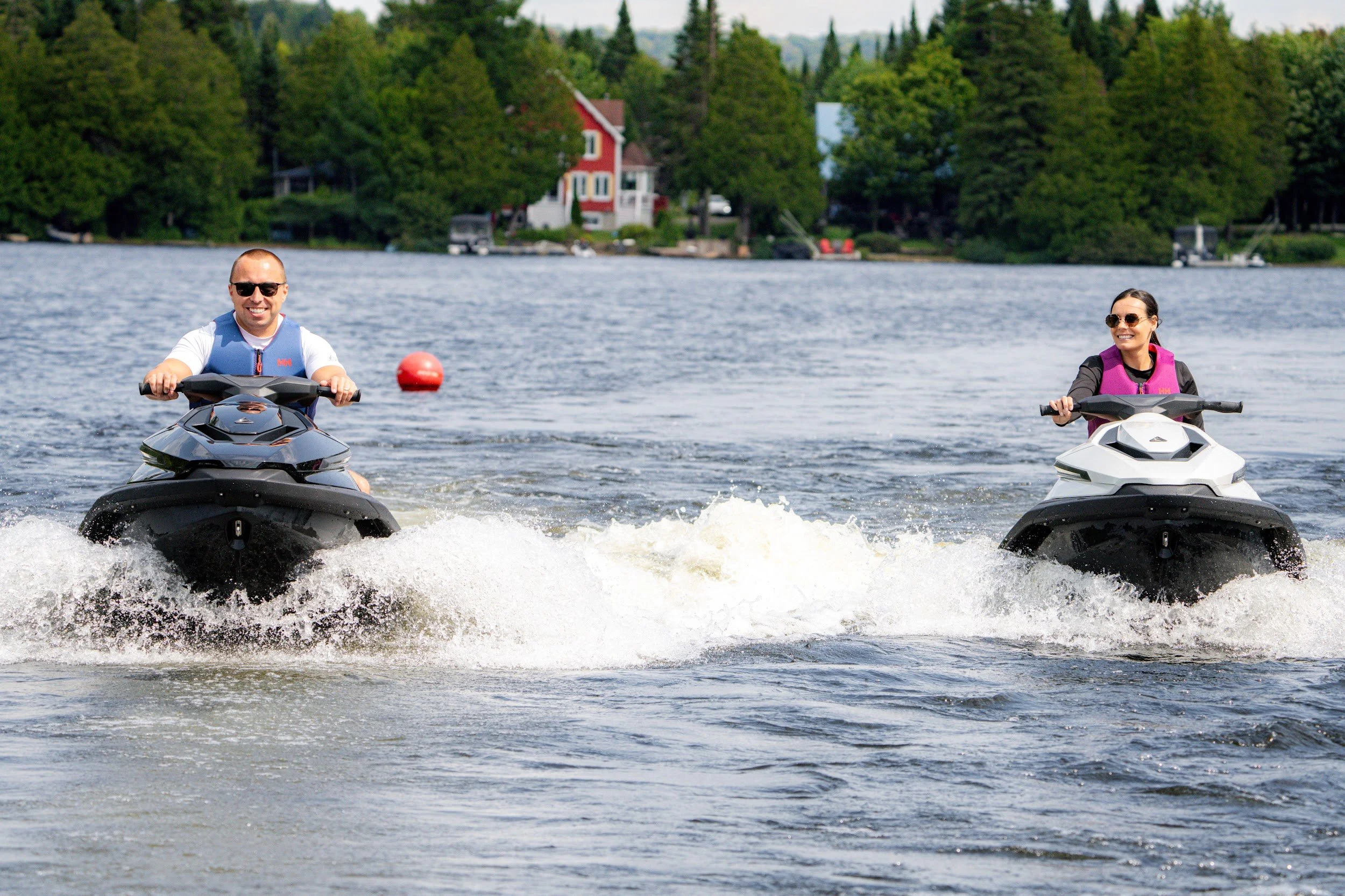 Two riders on Taiga Orcas coming toward the camera across the lake