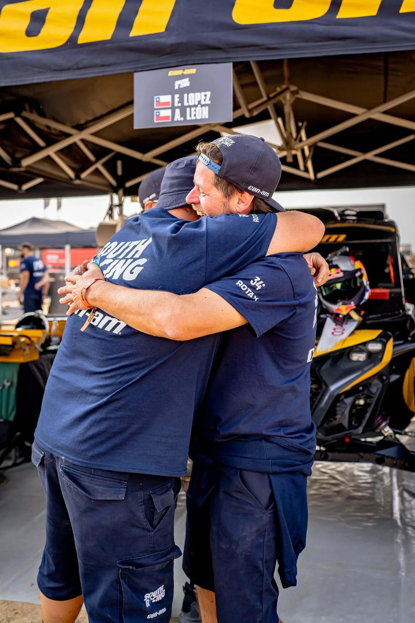 Two South Racing team members hugging at the bivouac