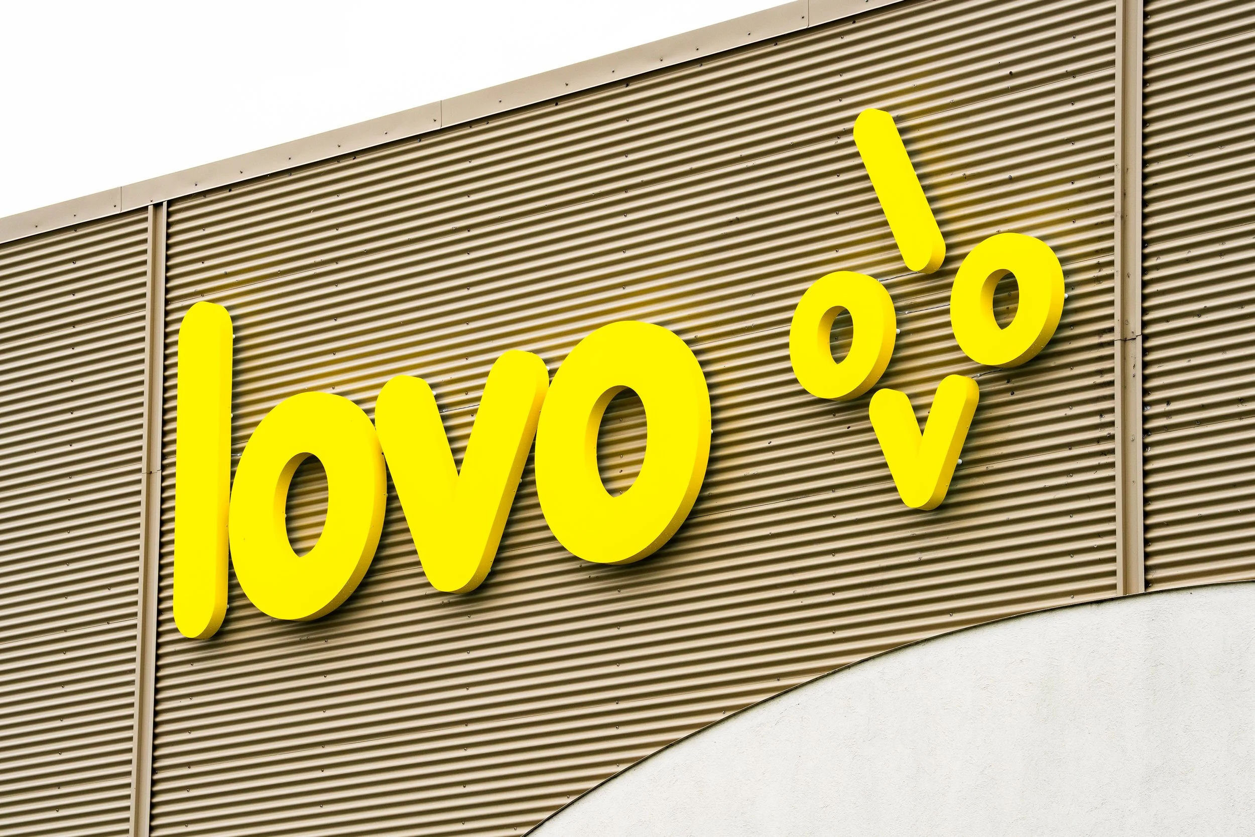 Yellow Lovo logo sign on a building wall