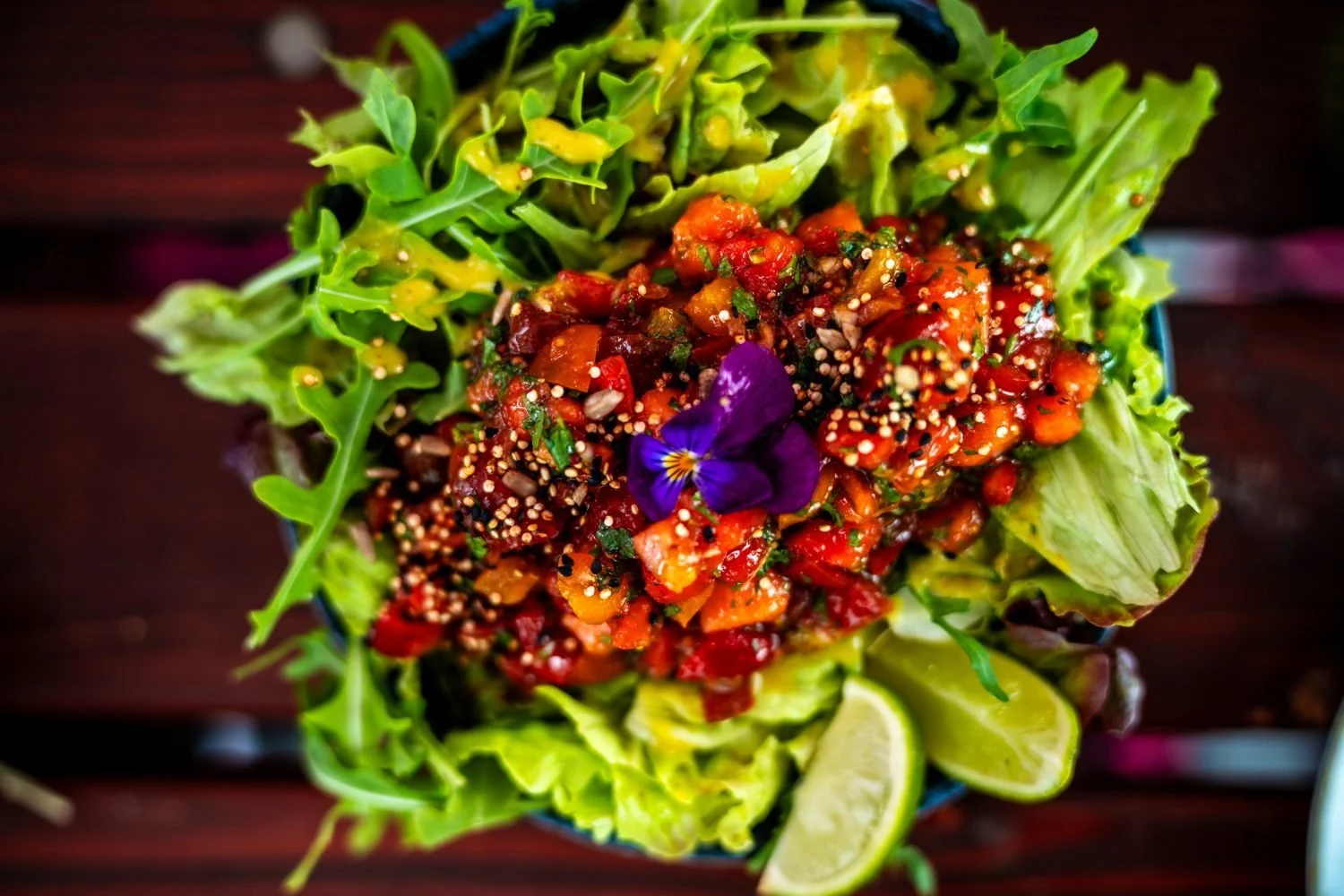A plate of greens, tomato and edible flowers served on the Portugal tour