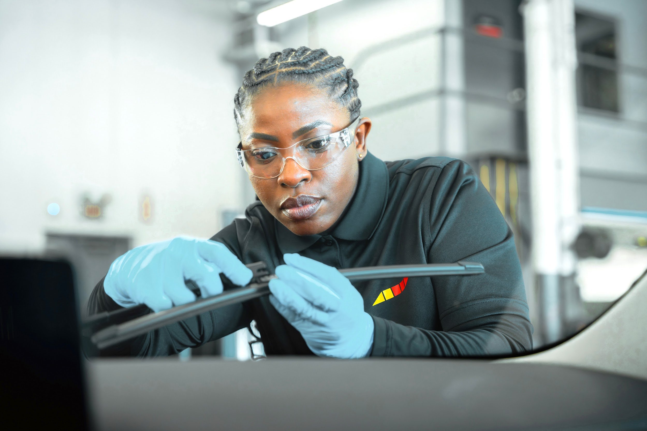 Technician fitting a new wiper blade, close on the hands