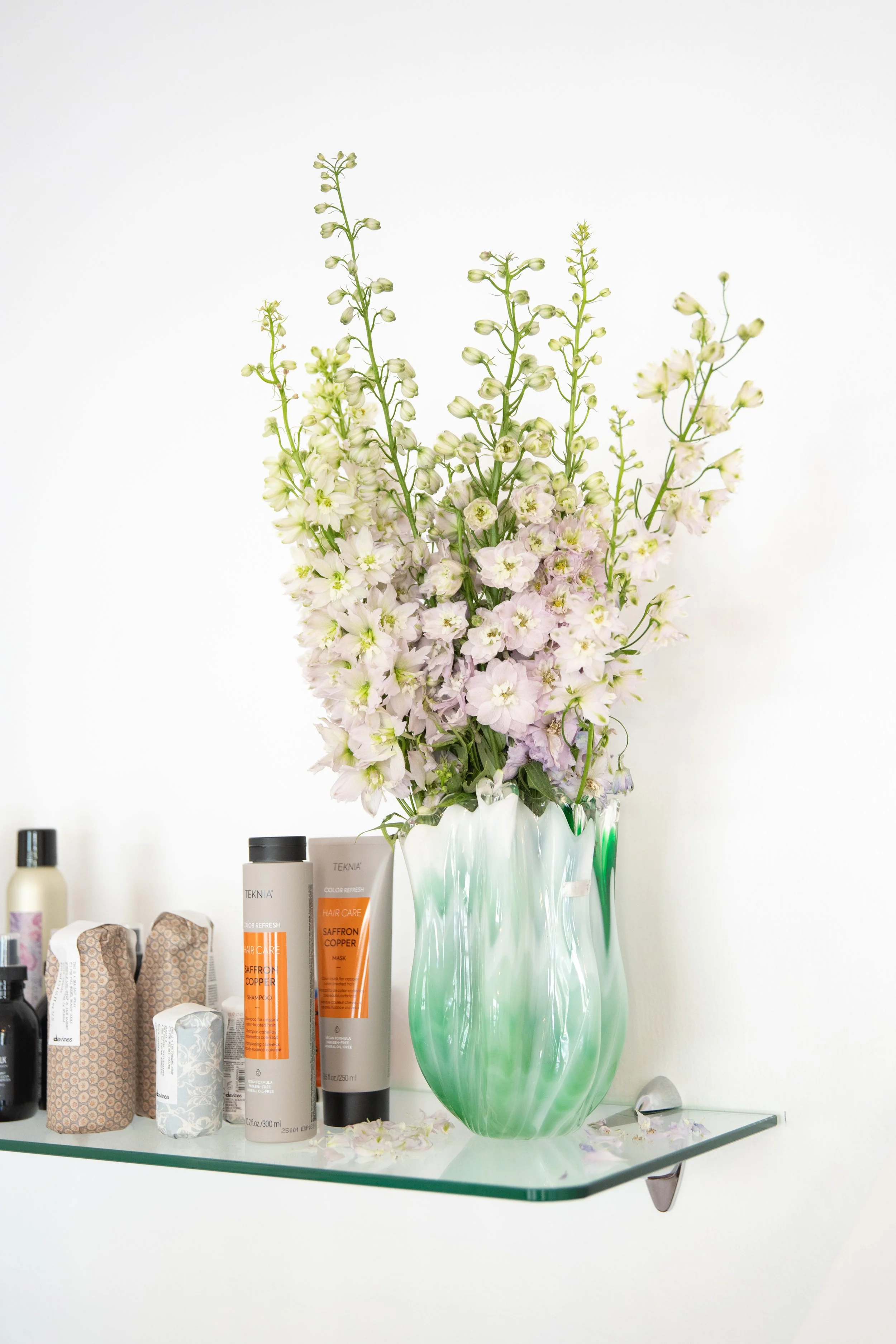 retail product shelf, davines hair product, flowers in vase
