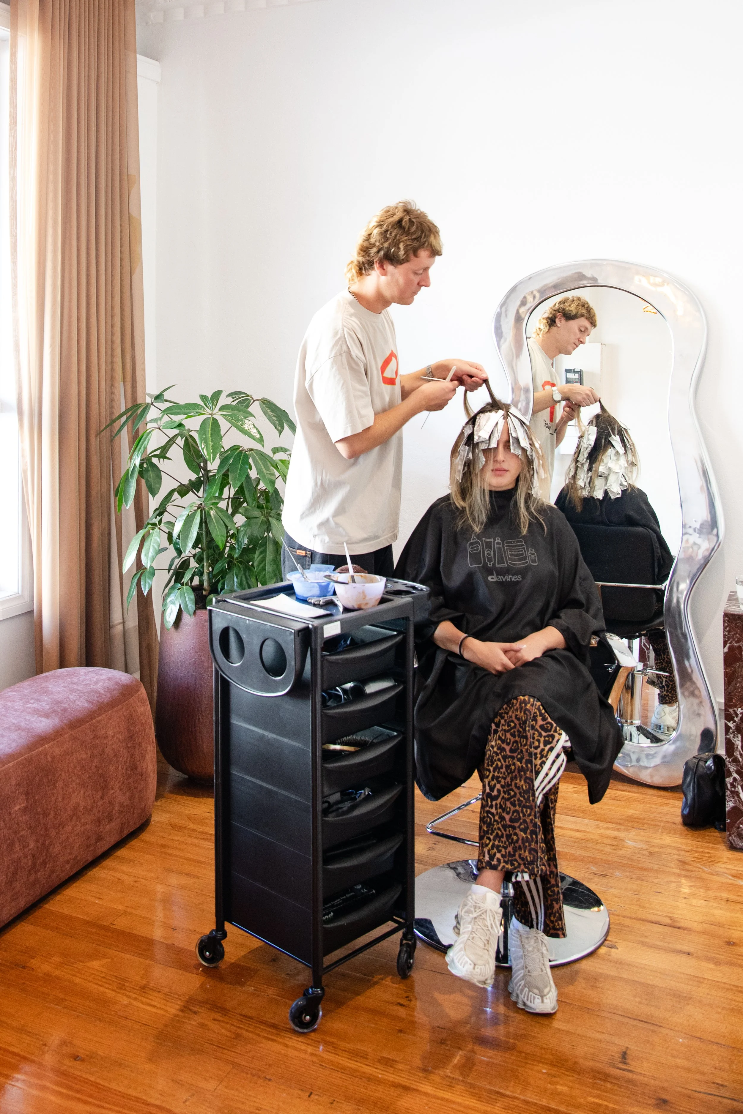 hairdresser working on blonde hair client. blonde specialist inner north melbourne