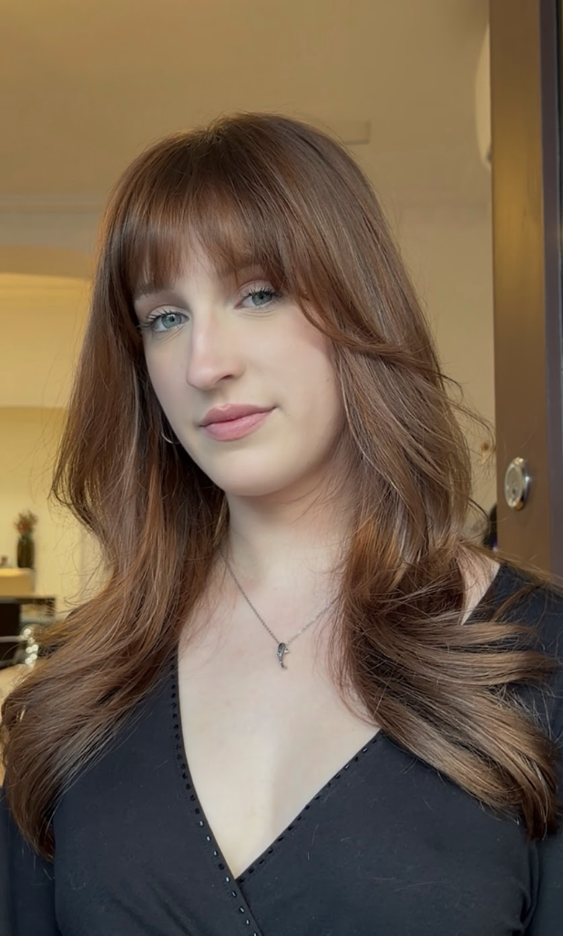glossy auburn hair, long 90's layerd haircut, curtain fringe.