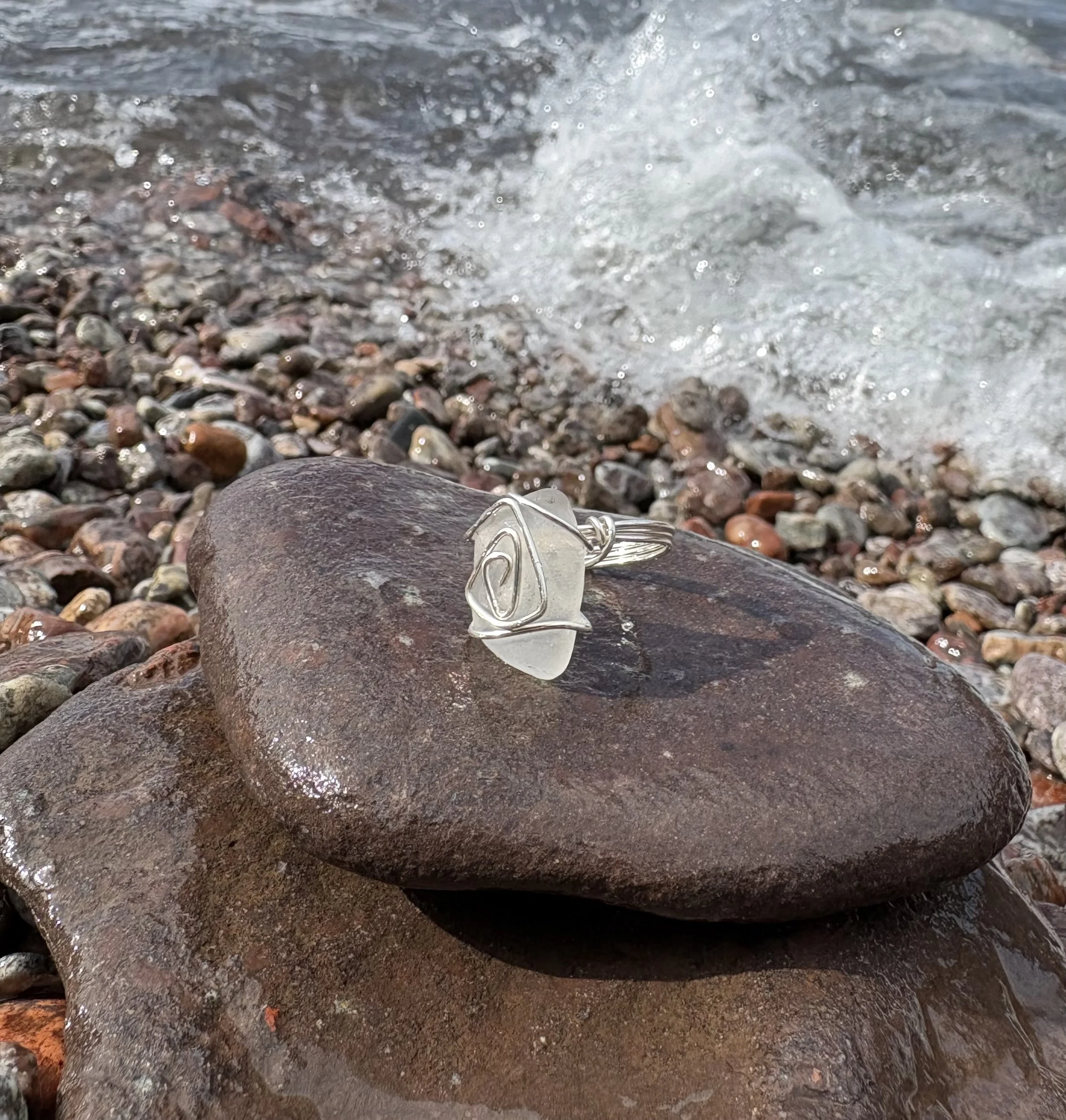 Close-up of rocky shoreline with water splashing over the stones.