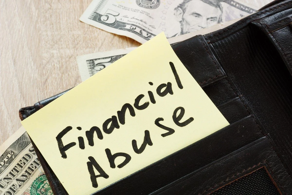 Note reading Financial Abuse tucked into a wallet
