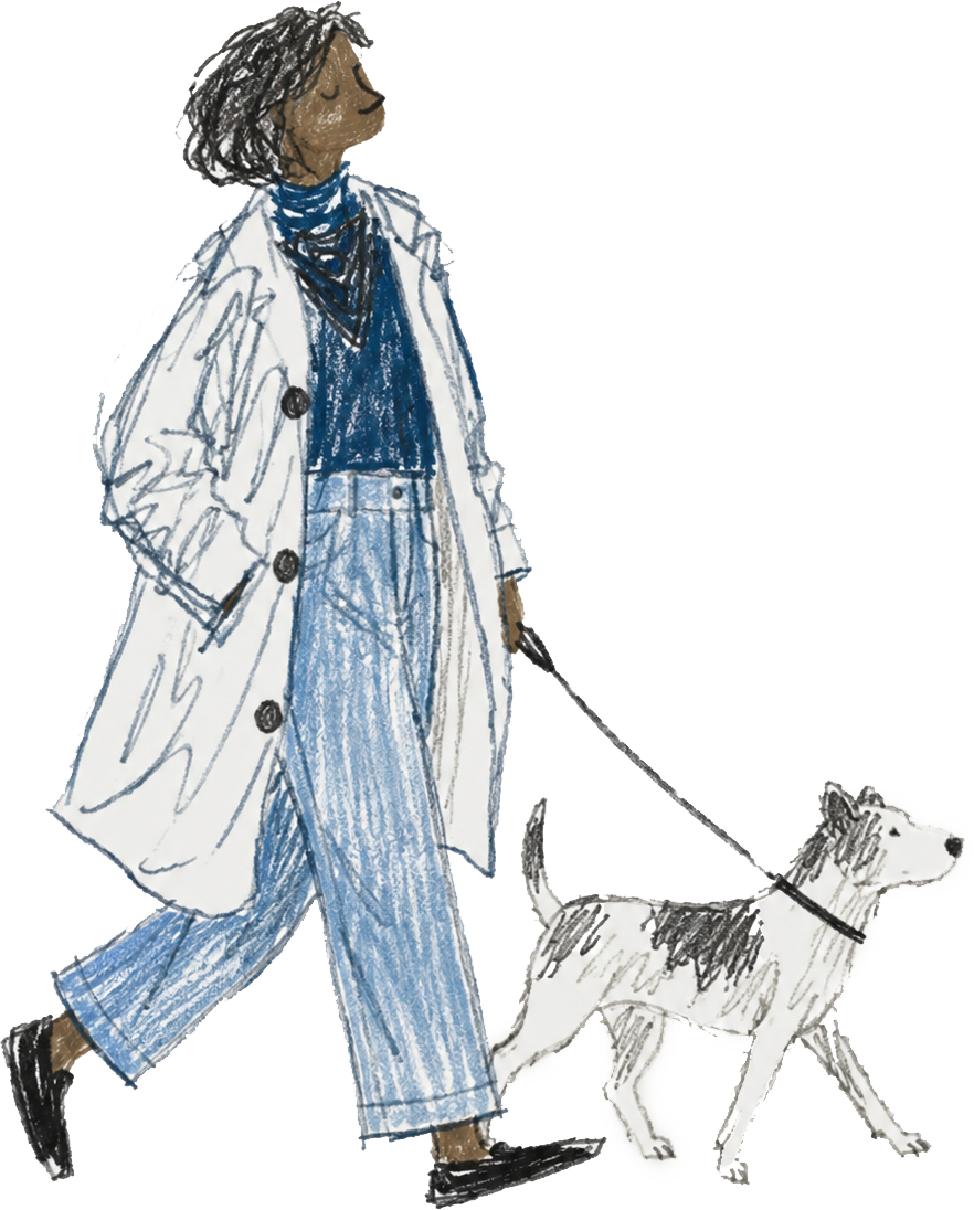 A woman walking a dog with a cityscape background, wearing a long white coat, blue pants, a blue top, and a scarf.