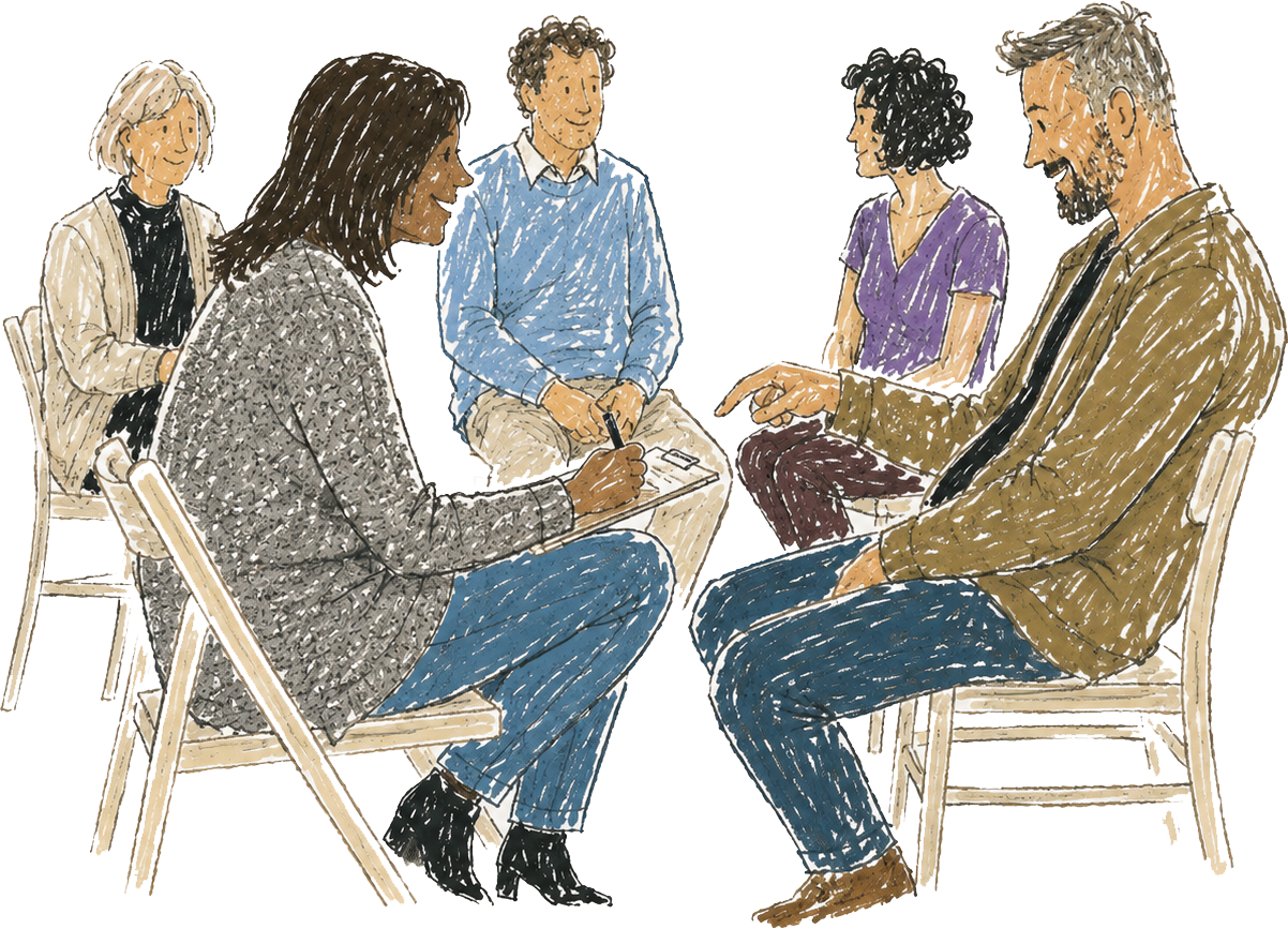 A group of five people having a therapy live demonstration in a circle, two women and three men, seated on wooden chairs, engaged in conversation, with one woman taking notes.
