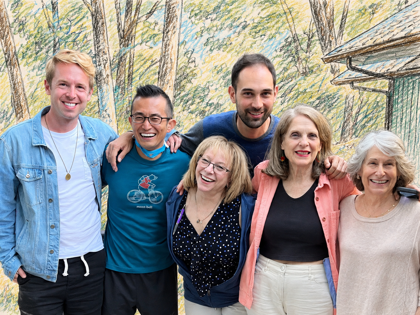 Group of seven people smiling and posing together outdoors, with a painted nature background showing trees and a house.
