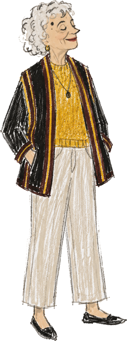 An elderly woman with curly white hair, wearing a striped blazer over a yellow blouse, beige wide-leg pants, and black shoes, standing with a confident pose and a slight smile.