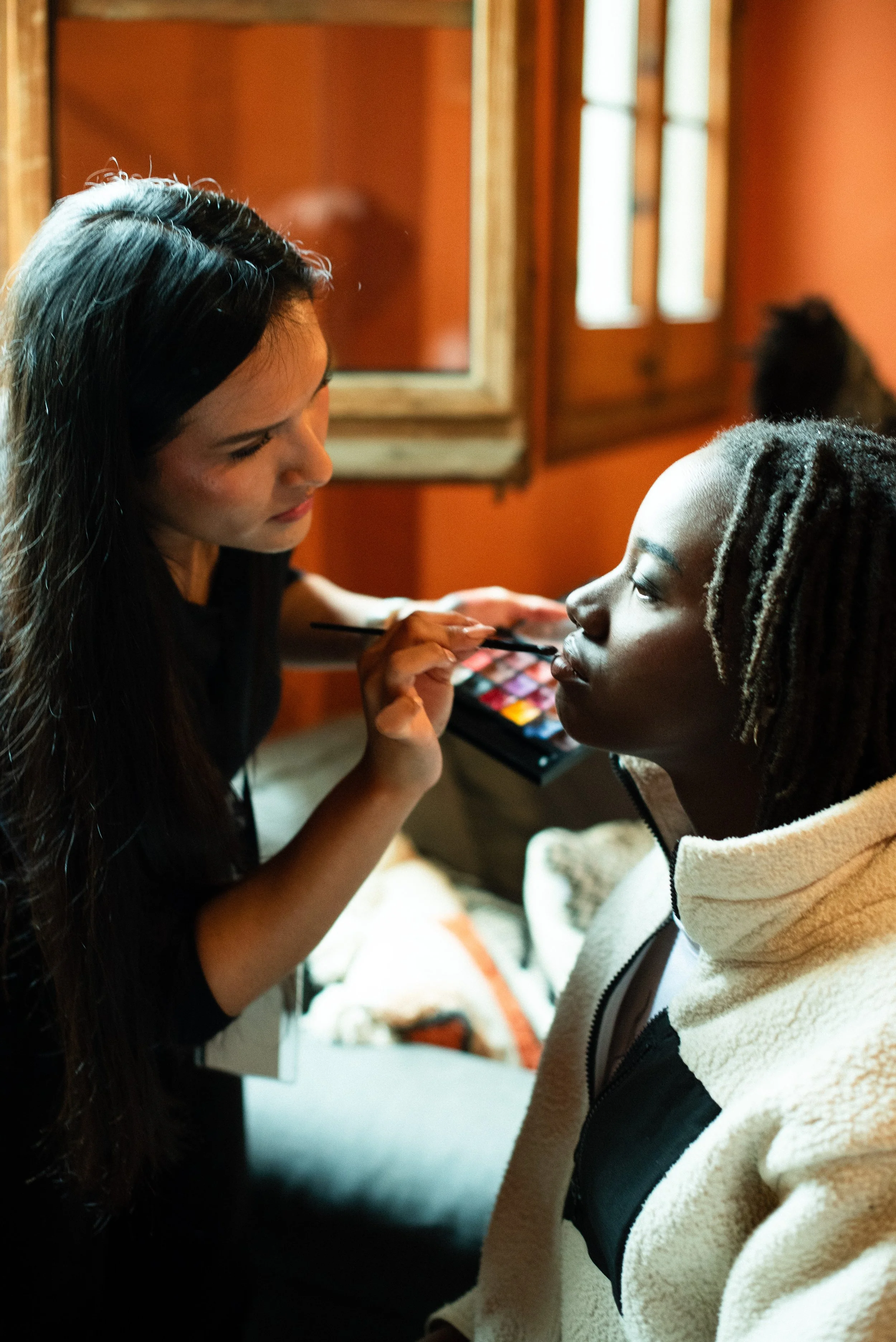 Dianna Manrique applying makeup to a client
