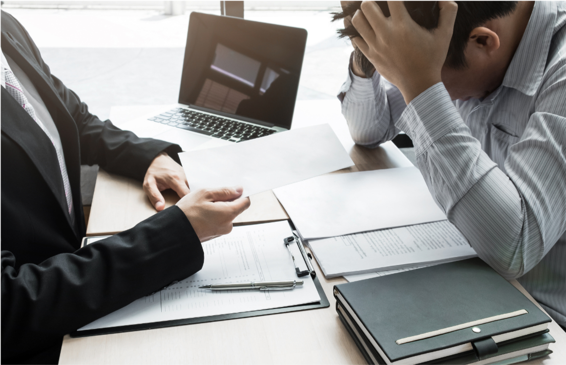 A distressed man in business attire receiving a letter from a woman during a business meeting.