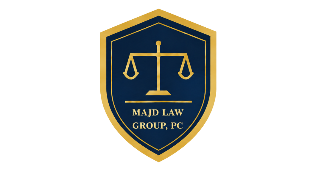 A shield emblem with scales of justice in gold on a dark blue background, bordered in gold, with the text "MAJD LAW GROUP, PC" below the scales.