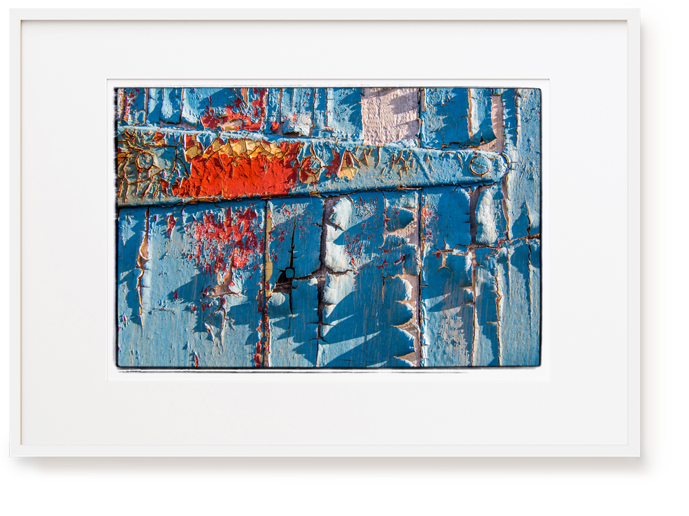Photograph by Erica Leather of a blue door with a rusty hinge detail