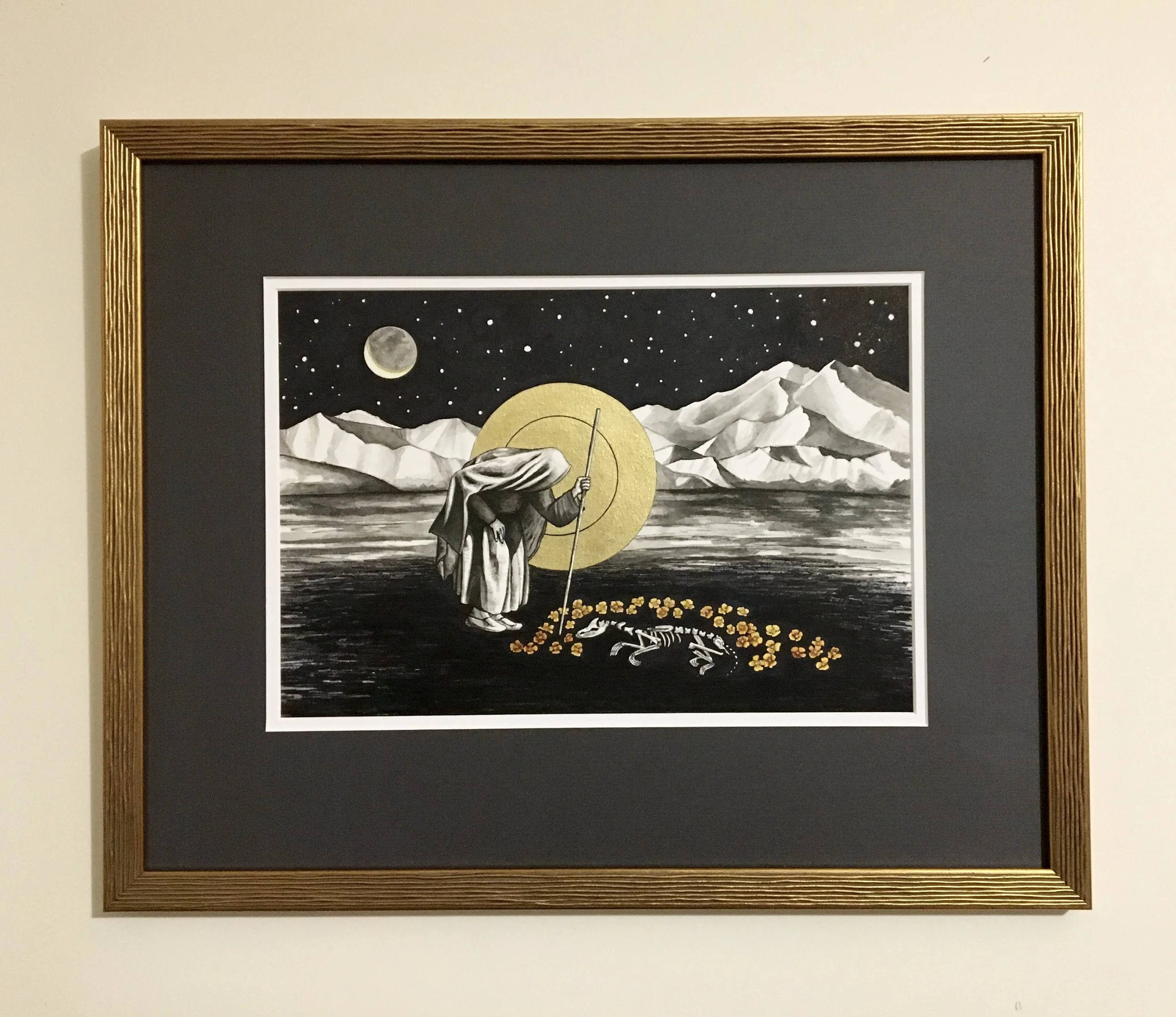 Painting by Cammie Blaisdell of a mountain landscape with snow-capped peaks, a full moon, a starry sky, and a figure with a staff in the foreground, framed with a gold textured border.