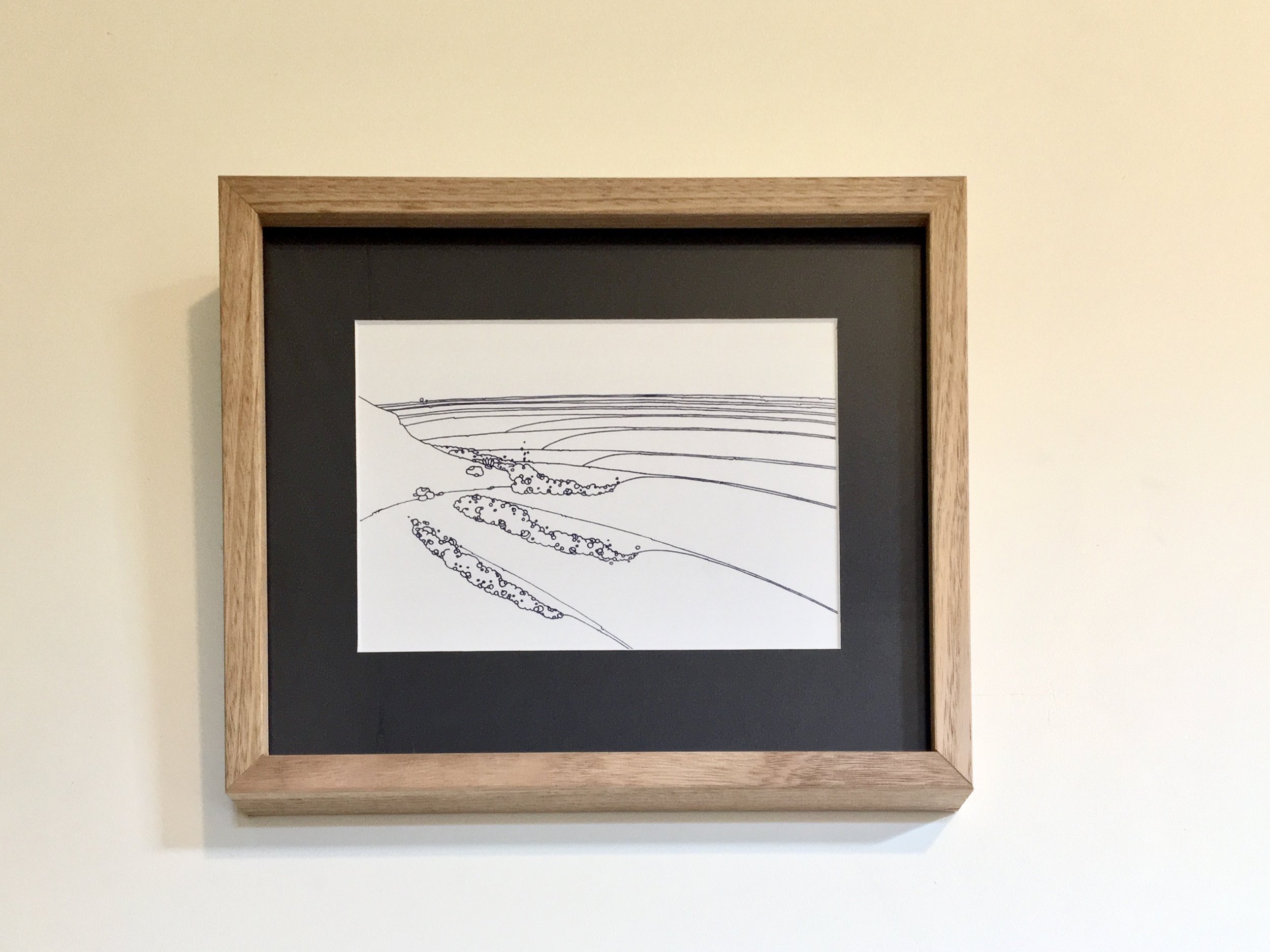 Framed abstract line drawing by Denise Fort of Raglan surf framed with a blue mount and wooden frame. 
