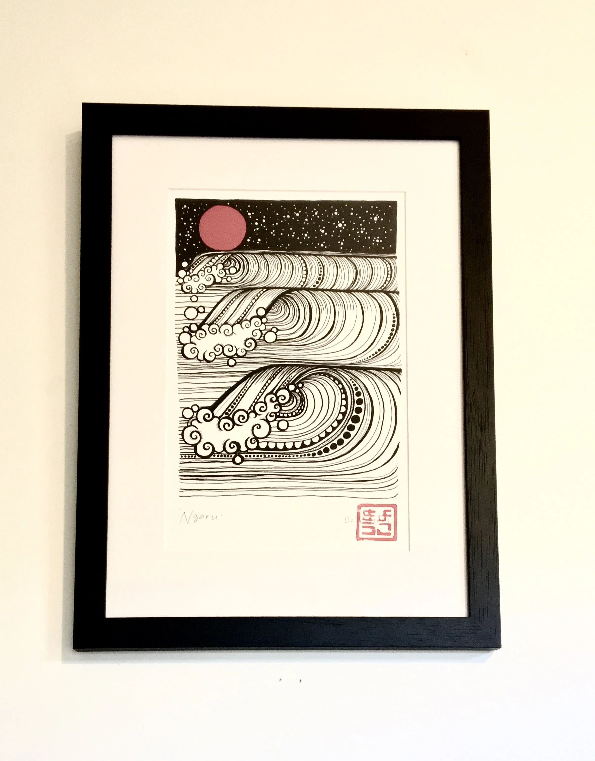Framed black and white illustration of stylized waves with a large red sun in a starry sky, signed by the artist and stamped with a red seal. By Ulo 