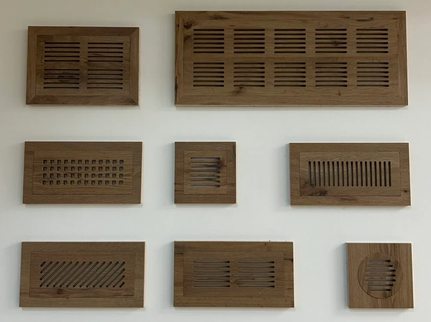 Collection of wooden slatted boxes of various sizes mounted on a white wall.