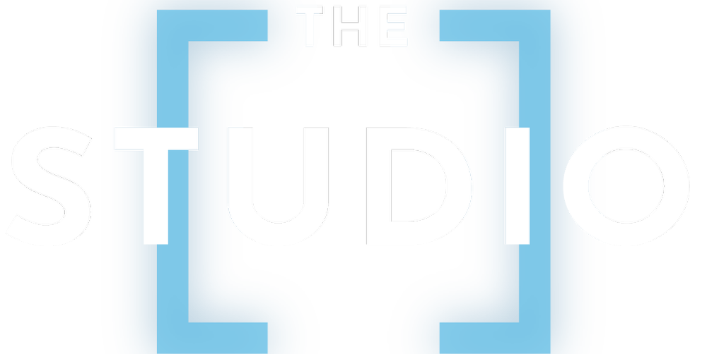 Logo with the words 'The Studio' in large white letters on a blue background with a film clamp graphic.
