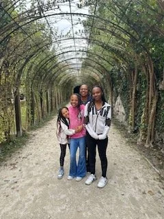 The Hamm daughters on a tree-lined garden path