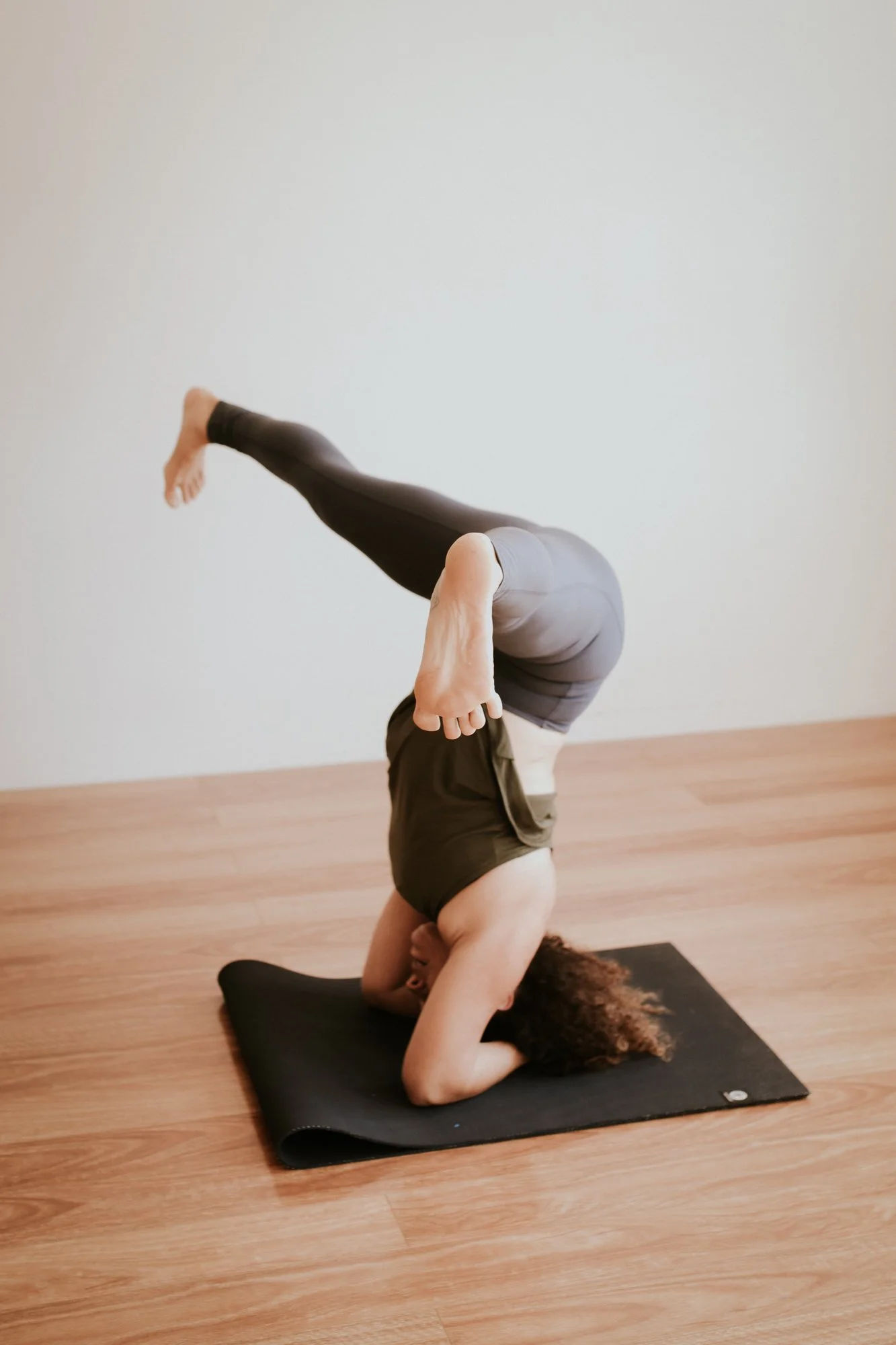 Student practising a supported headstand during an Iyengar Yoga class at yoga whitianga