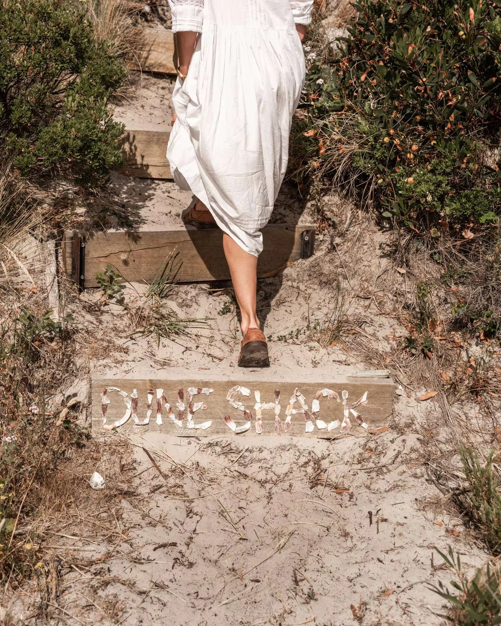 Sandy path through the dune scrub to the beach, with a hand-painted Beach sign