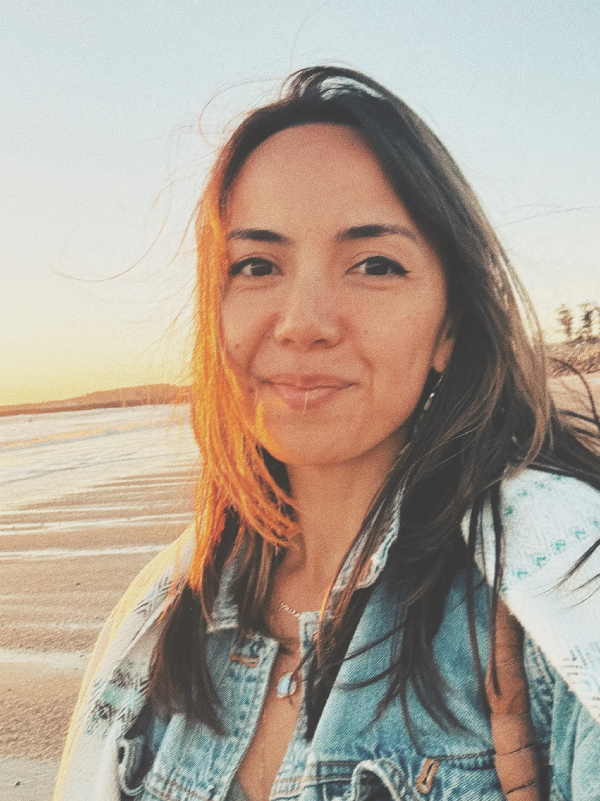 Michelle McNamee, founder of Unveiling Venus, photographed at the beach during sunset.