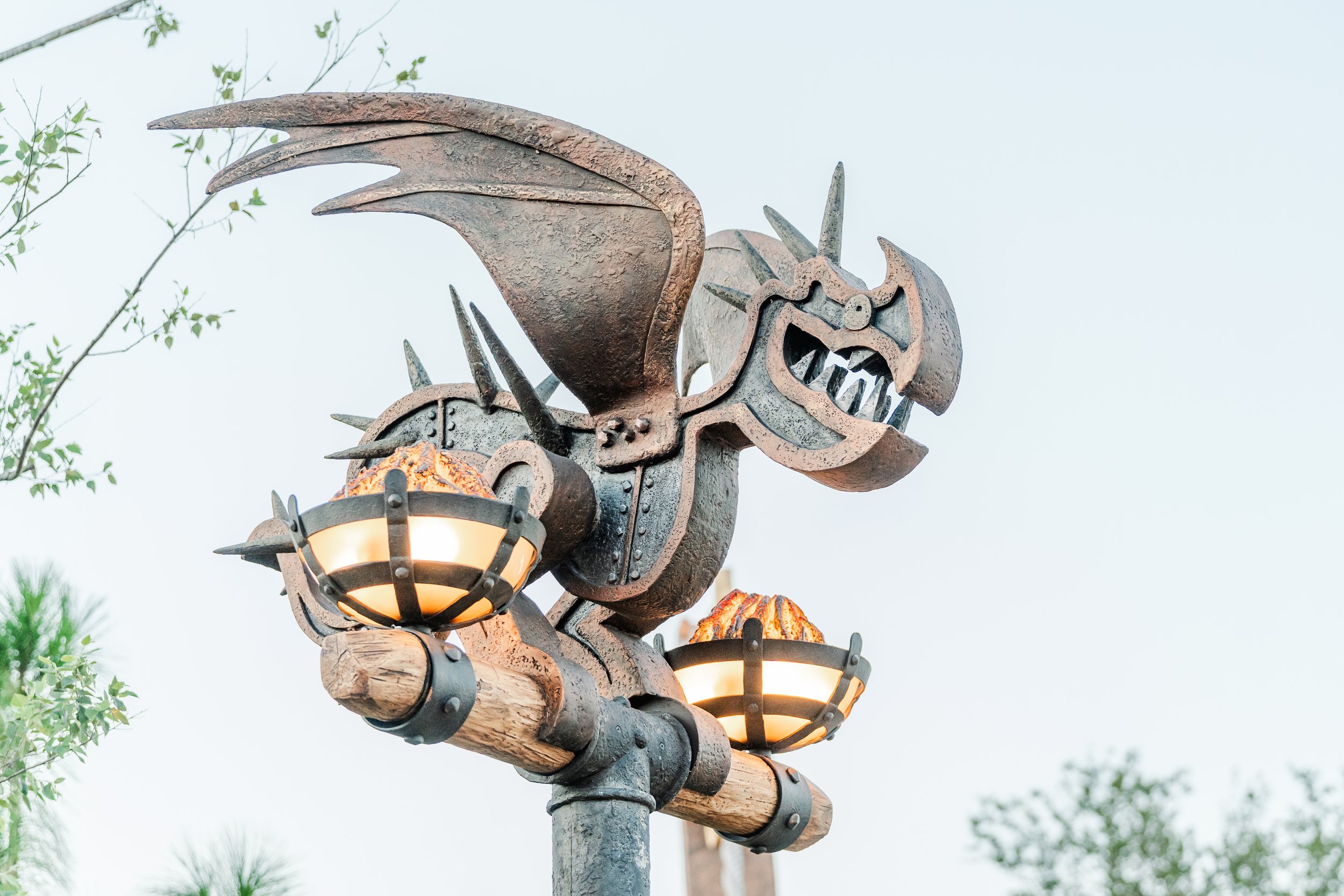 A decorative streetlamp featuring a dragon design with flames around it, possibly inspired by fantasy or medieval themes.