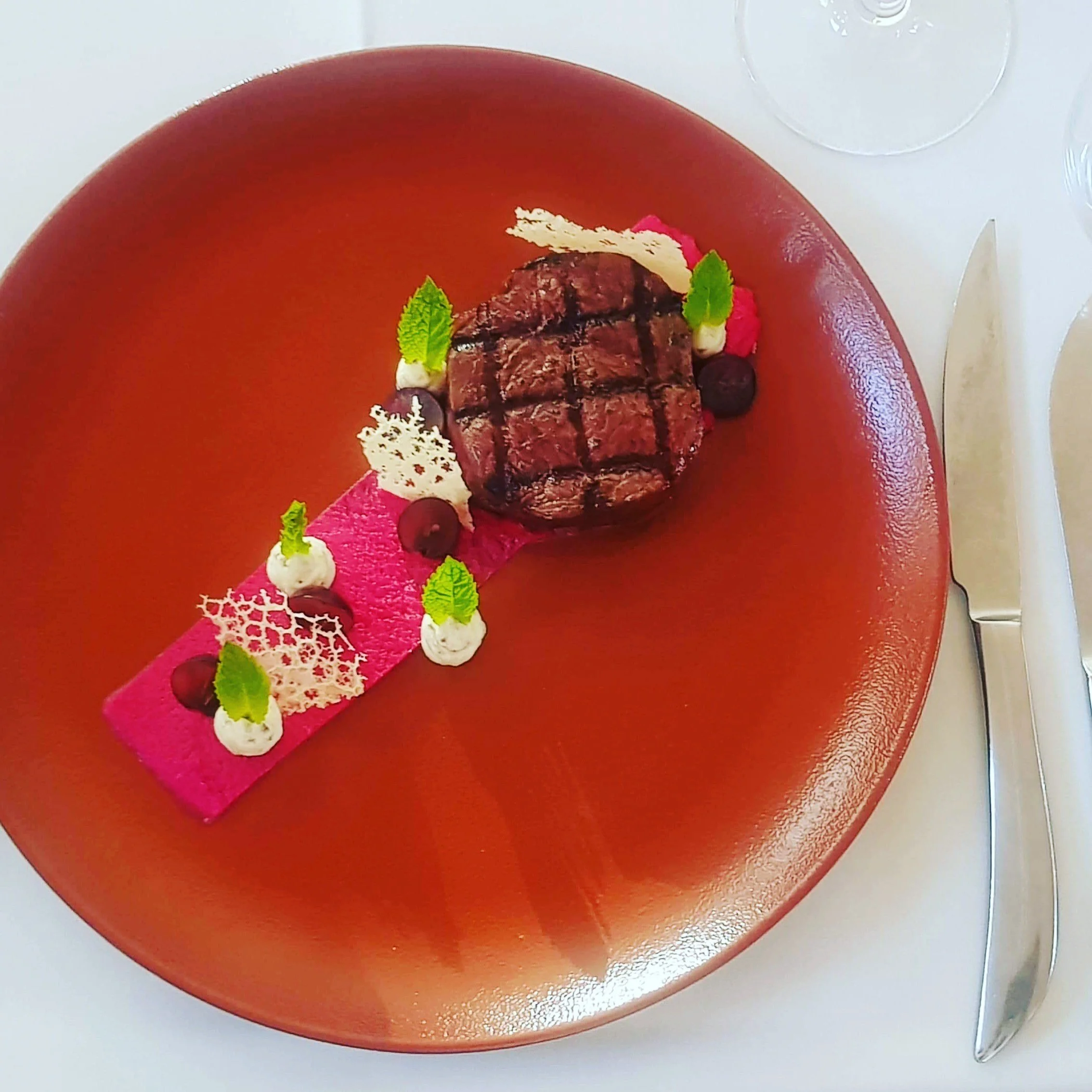 South Australian red kangaroo steak with beetroot puree, pickled grapes, cultured cream and tuile blanche.