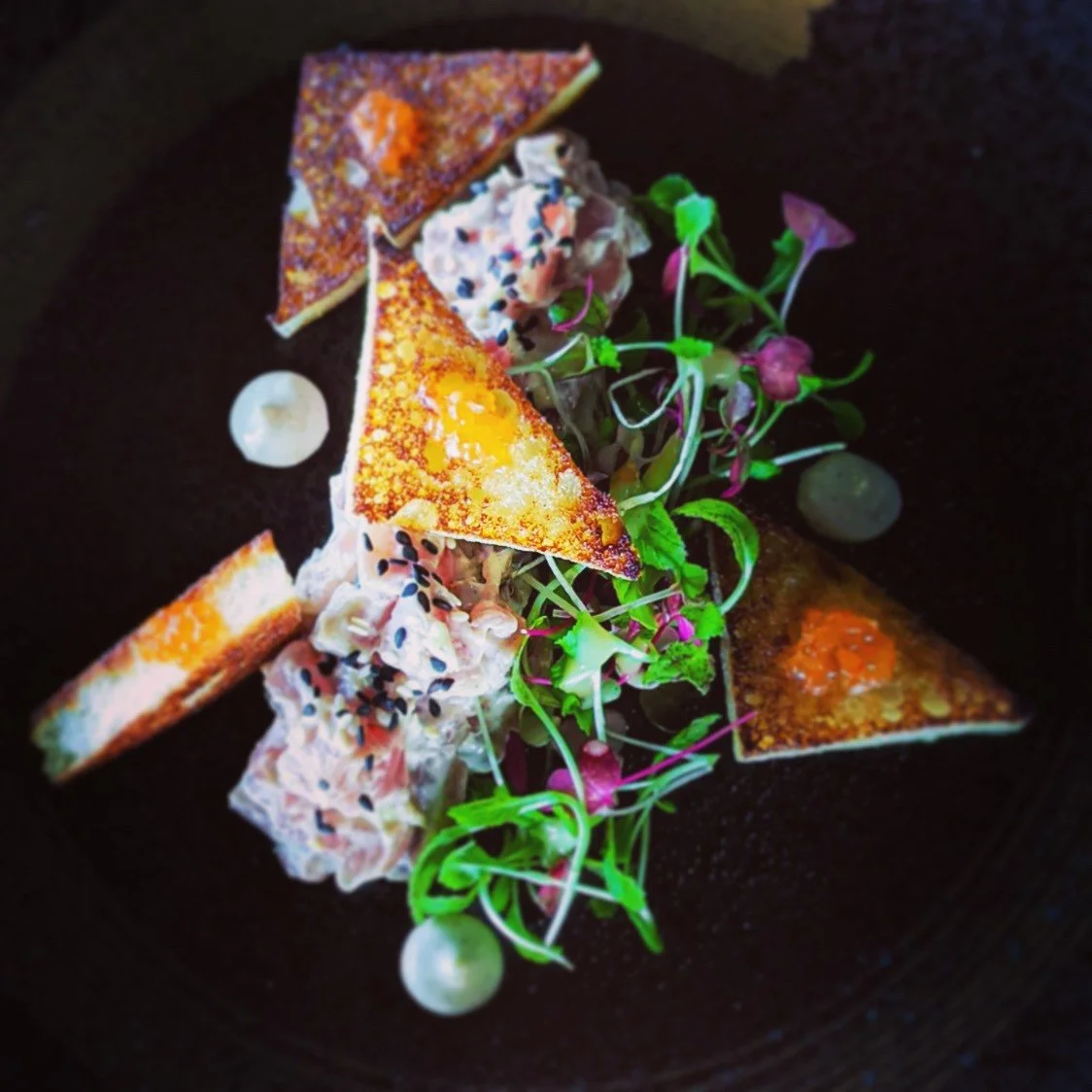 Tasmanian-caught blue fin tuna tartare with yuzu gel, black sesame, toasted sourdough and micro herbs.
