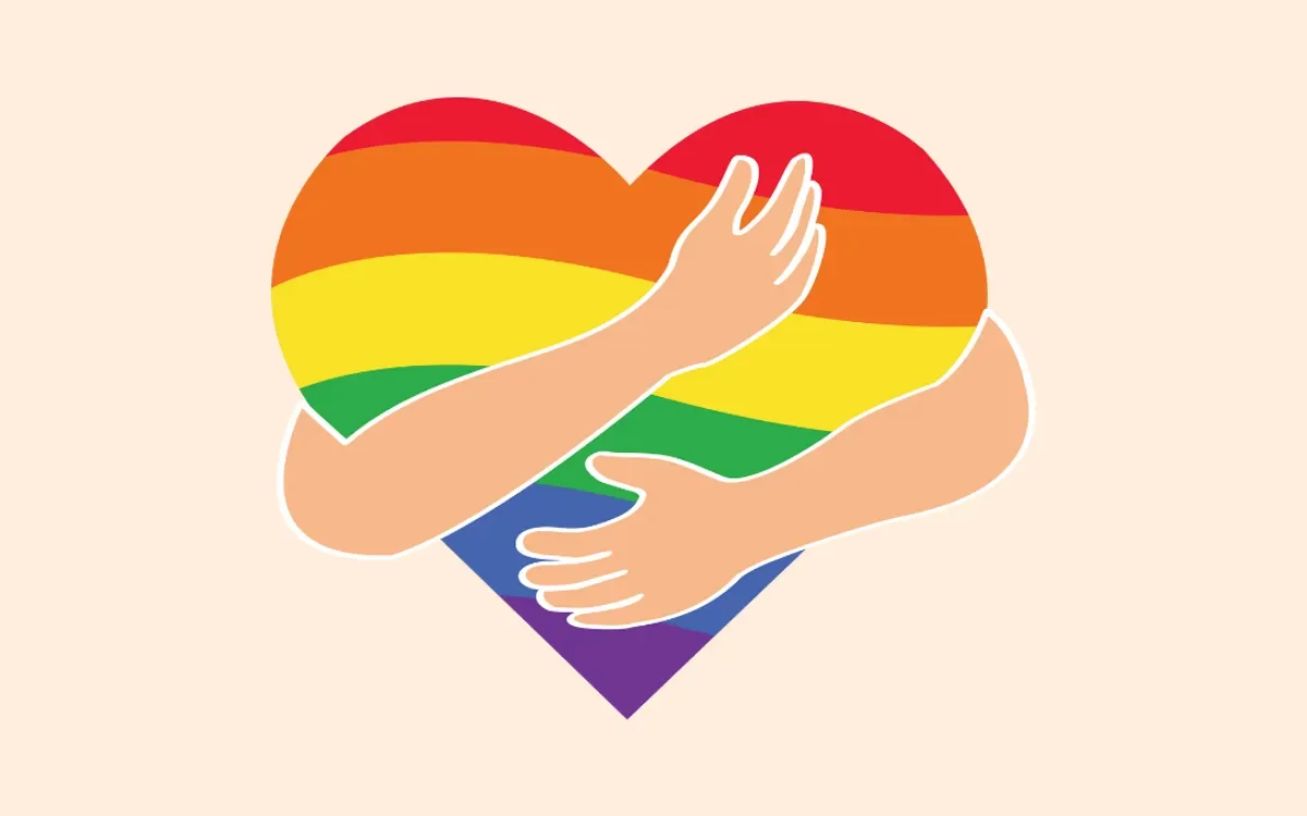 A heart with rainbow stripes representing LGBTQ+ pride being hugged by two arms.