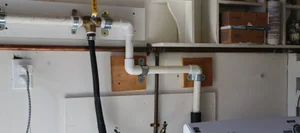 Laundry greywater diverter plumbing on a wall