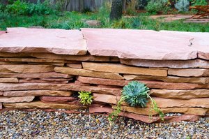 Dry-stacked flagstone planter wall edged with gravel