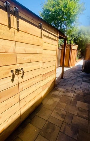 Horizontal cedar fence and gate along a side path
