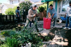 Elizabeth Sarmiento working with her crew in a client garden