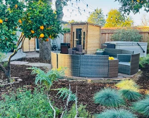 Backyard lounge area beside a garden studio