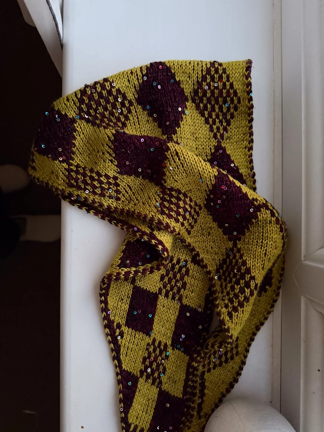 Harlequin Gambit scarf draped to show the diamond and Checkmate faces together