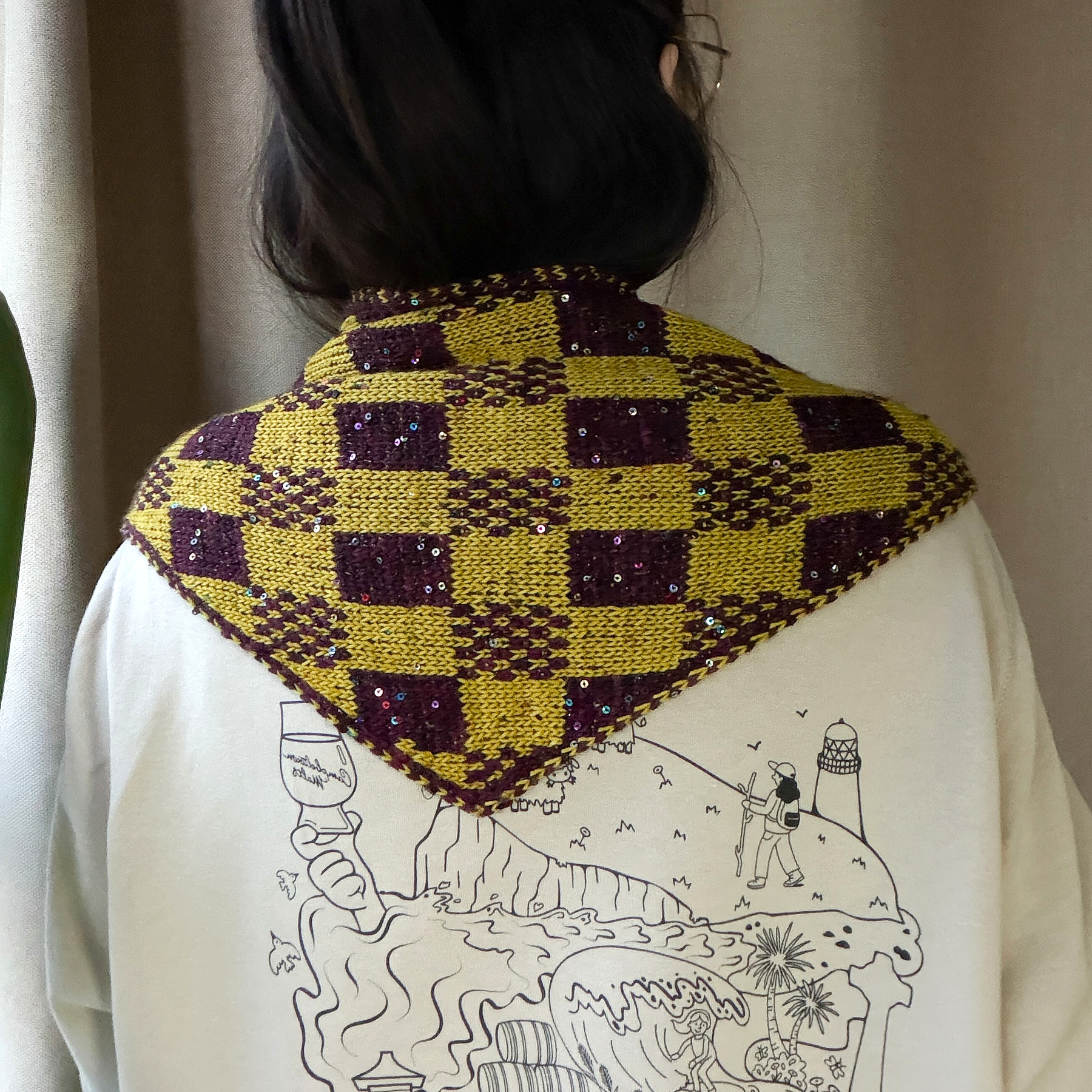 Back view of Qing wearing Harlequin Checkmate; bright natural lighting and restrained warm yellow-green colour