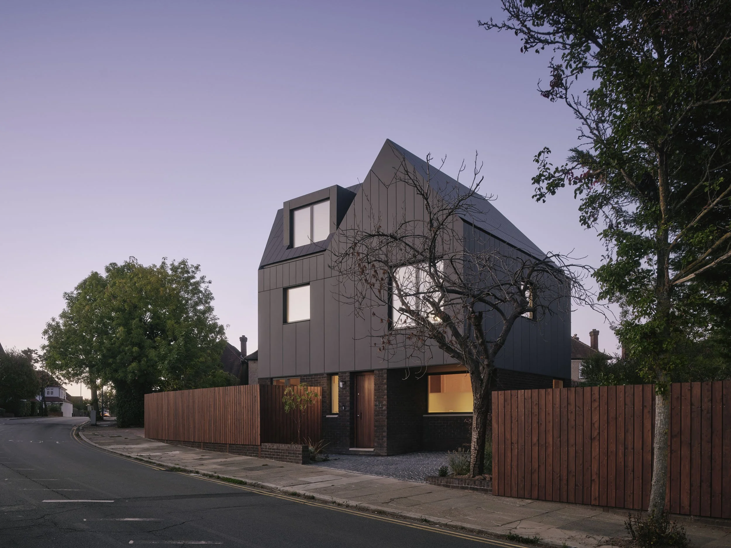 Wood House at dusk, designed and built by 538 Works