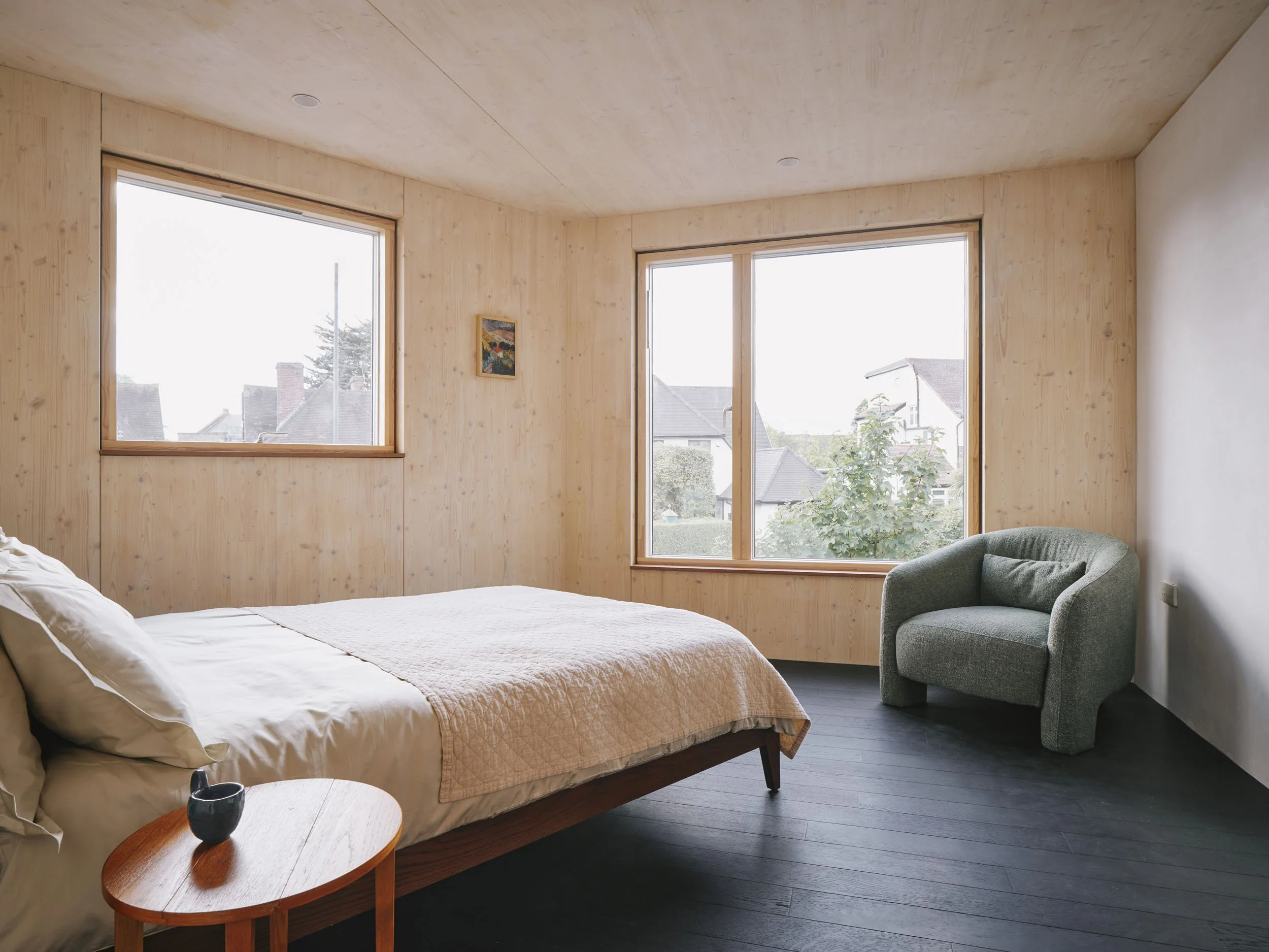 Bedroom with timber walls and a view over the street
