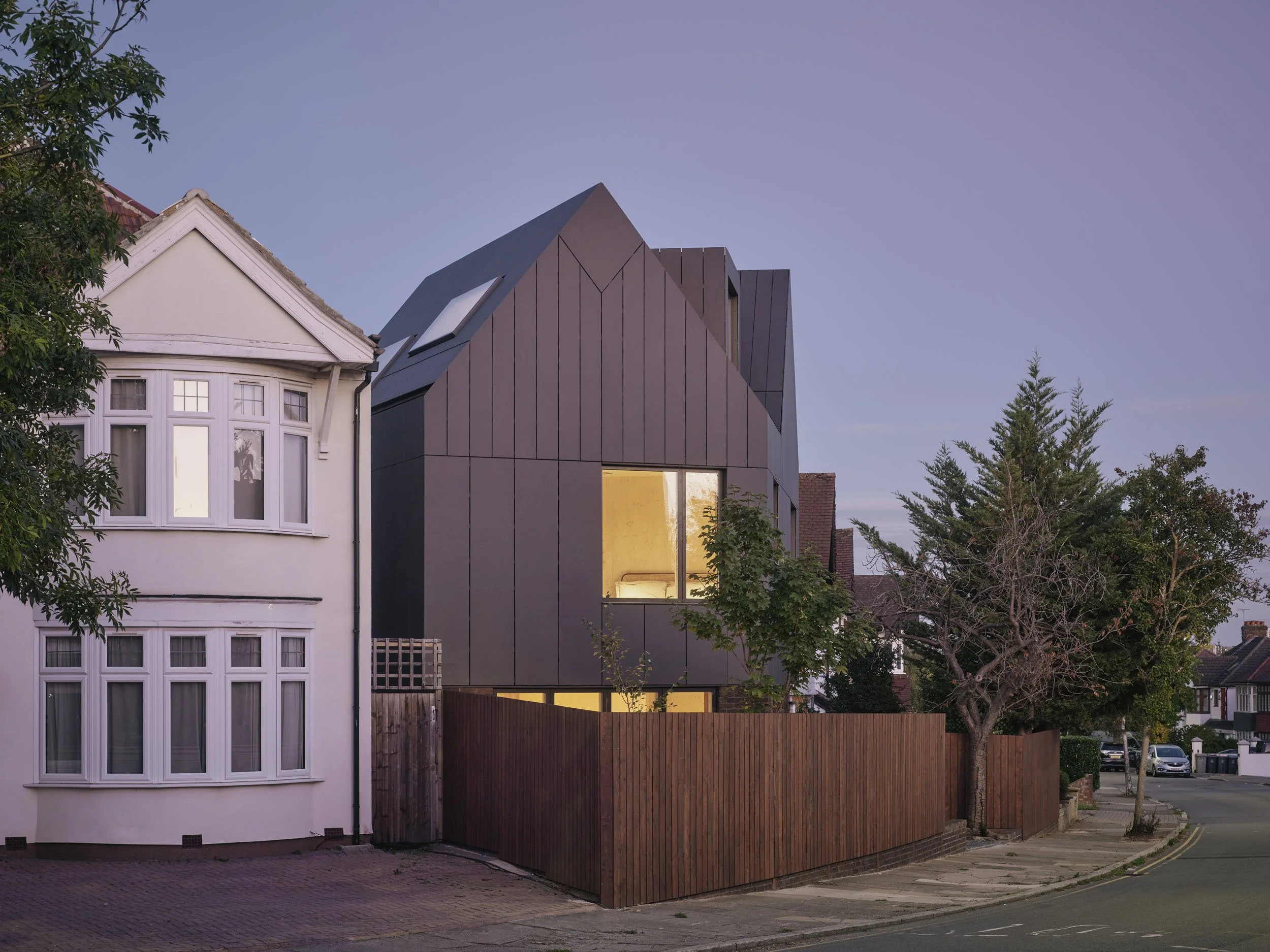 Wood House by 538 Works at dusk, a CLT home on a tight infill site in north-west London