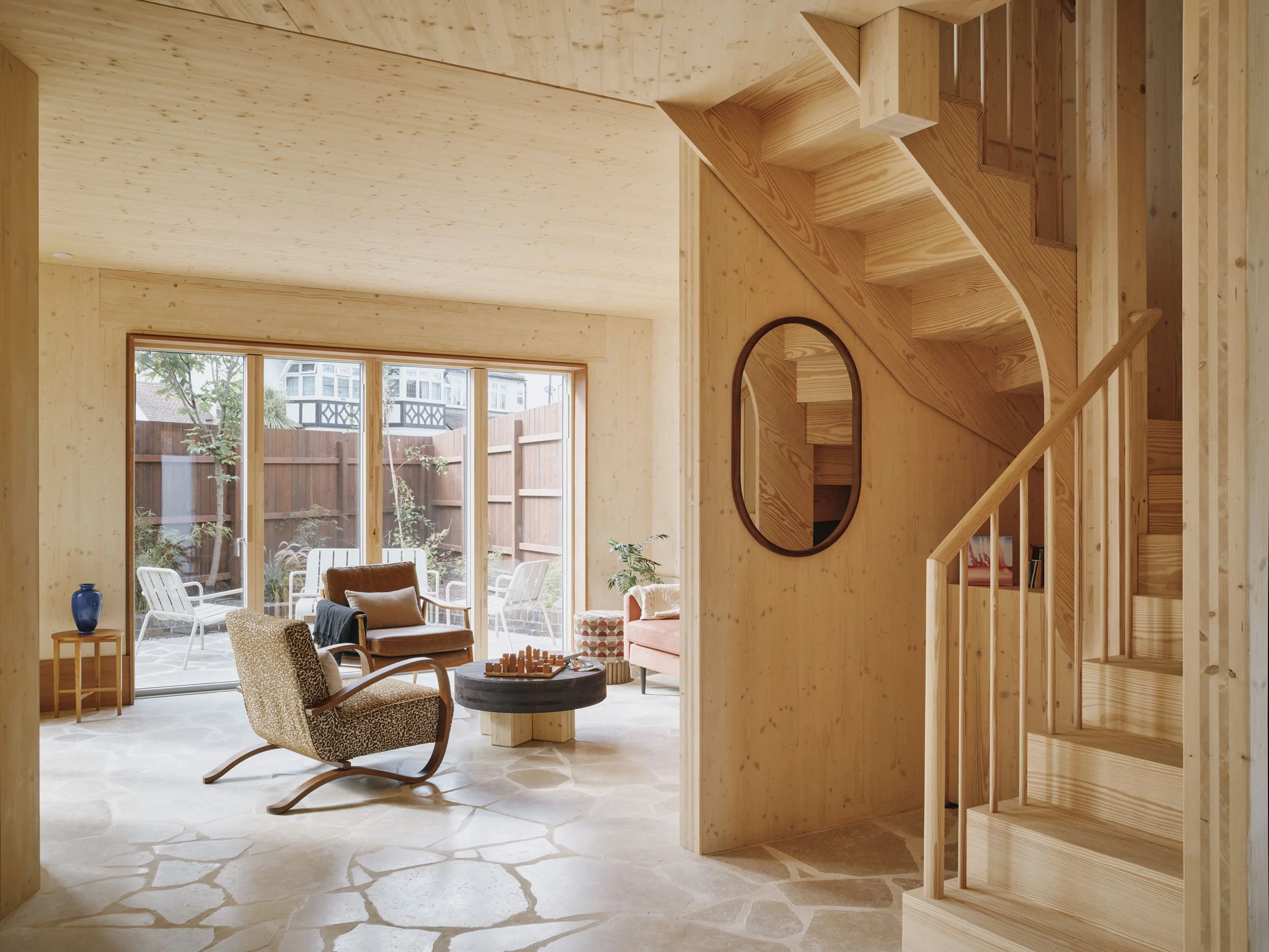 Ground-floor living room and timber stair in Wood House by 538 Works