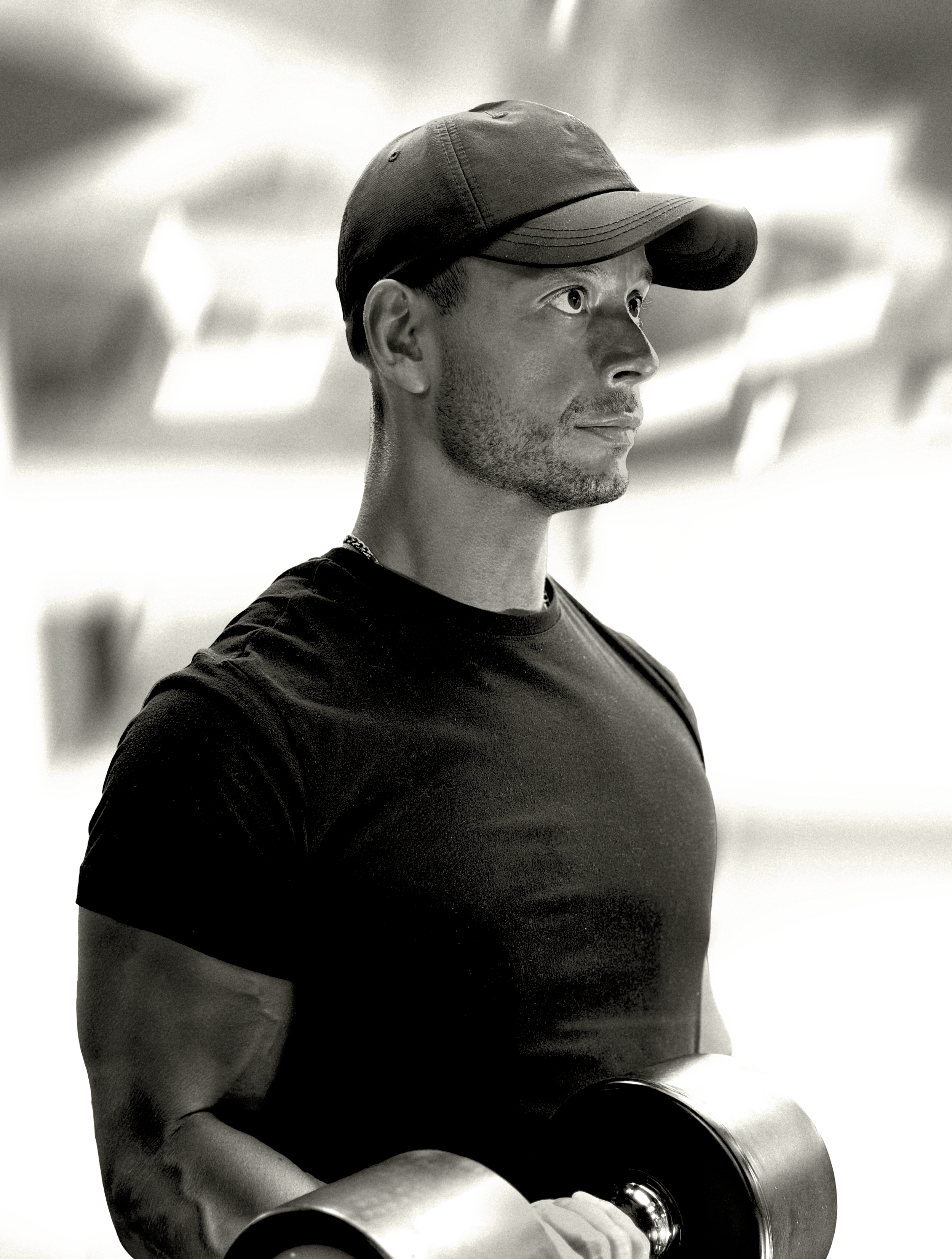 Personal trainer Raffaele Ragno training with a dumbbell in a London gym.