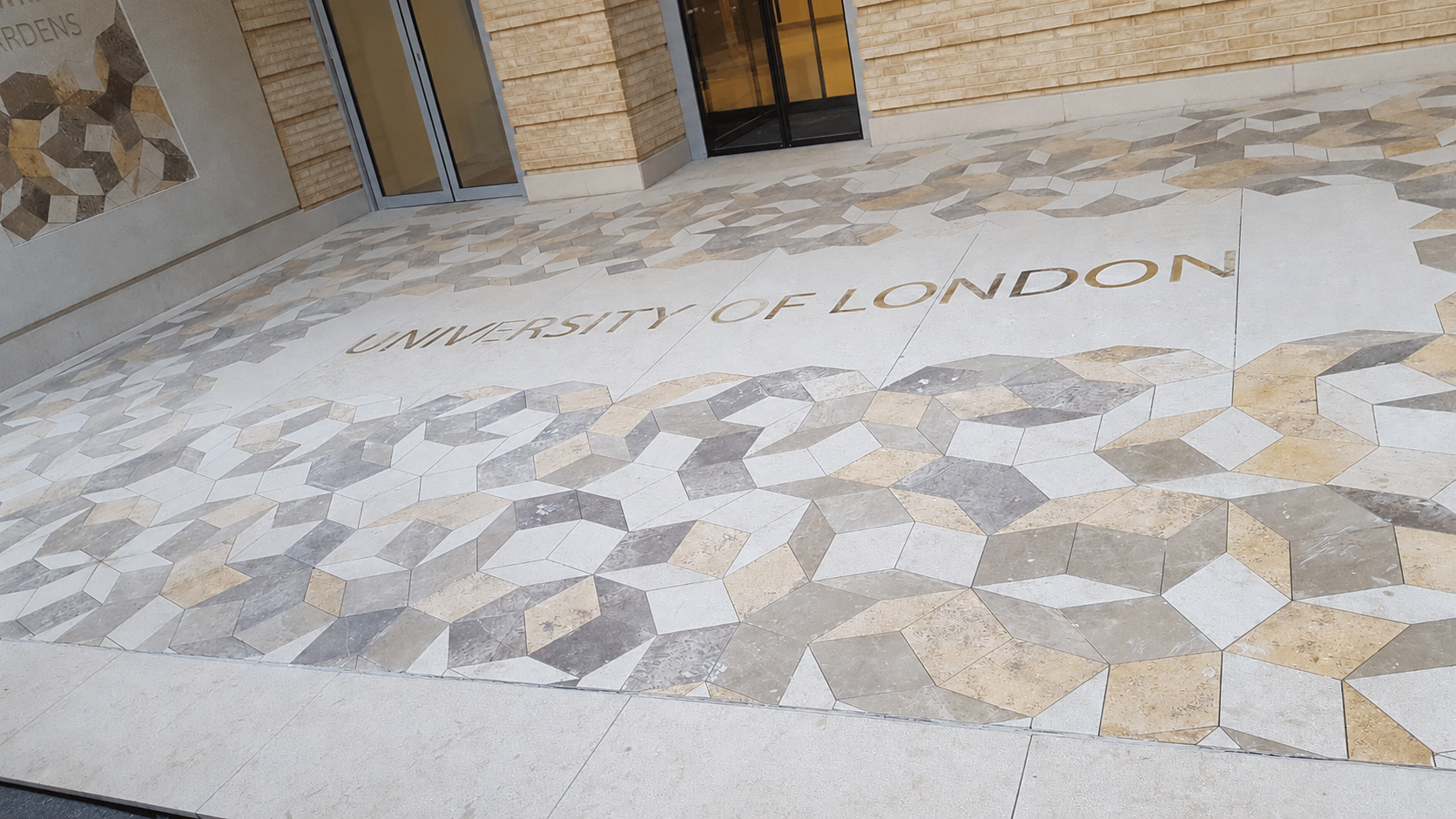 University of London entrance courtyard with mosaic stone pavement and geometric wall artwork