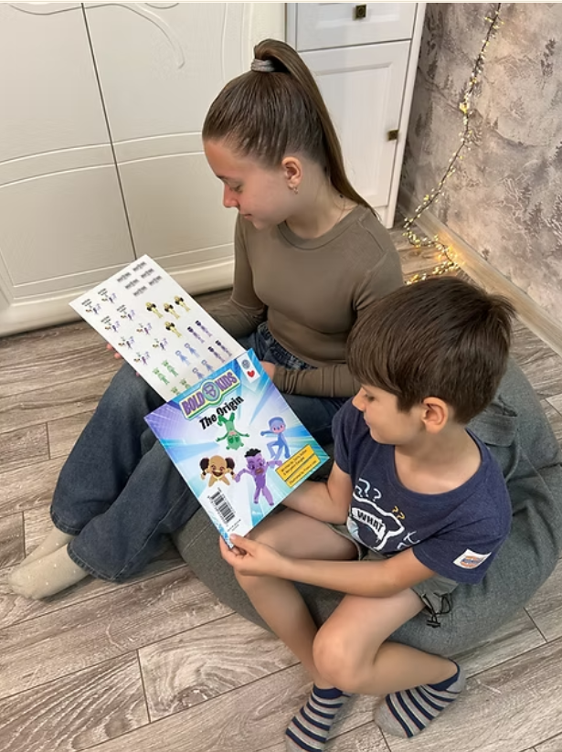 Young brother and sister holding the bold kids the origin book smiling