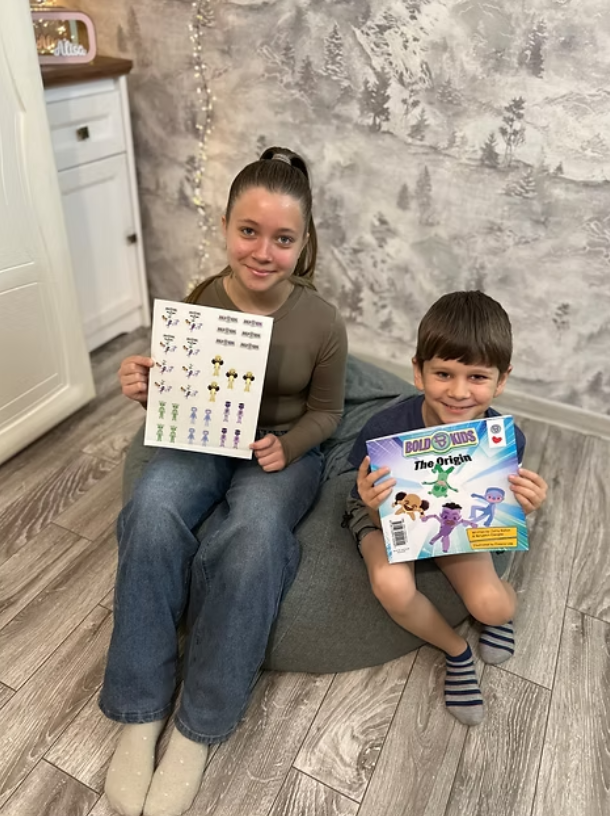 Young sister and brother holding the bold kids the origin book smiling