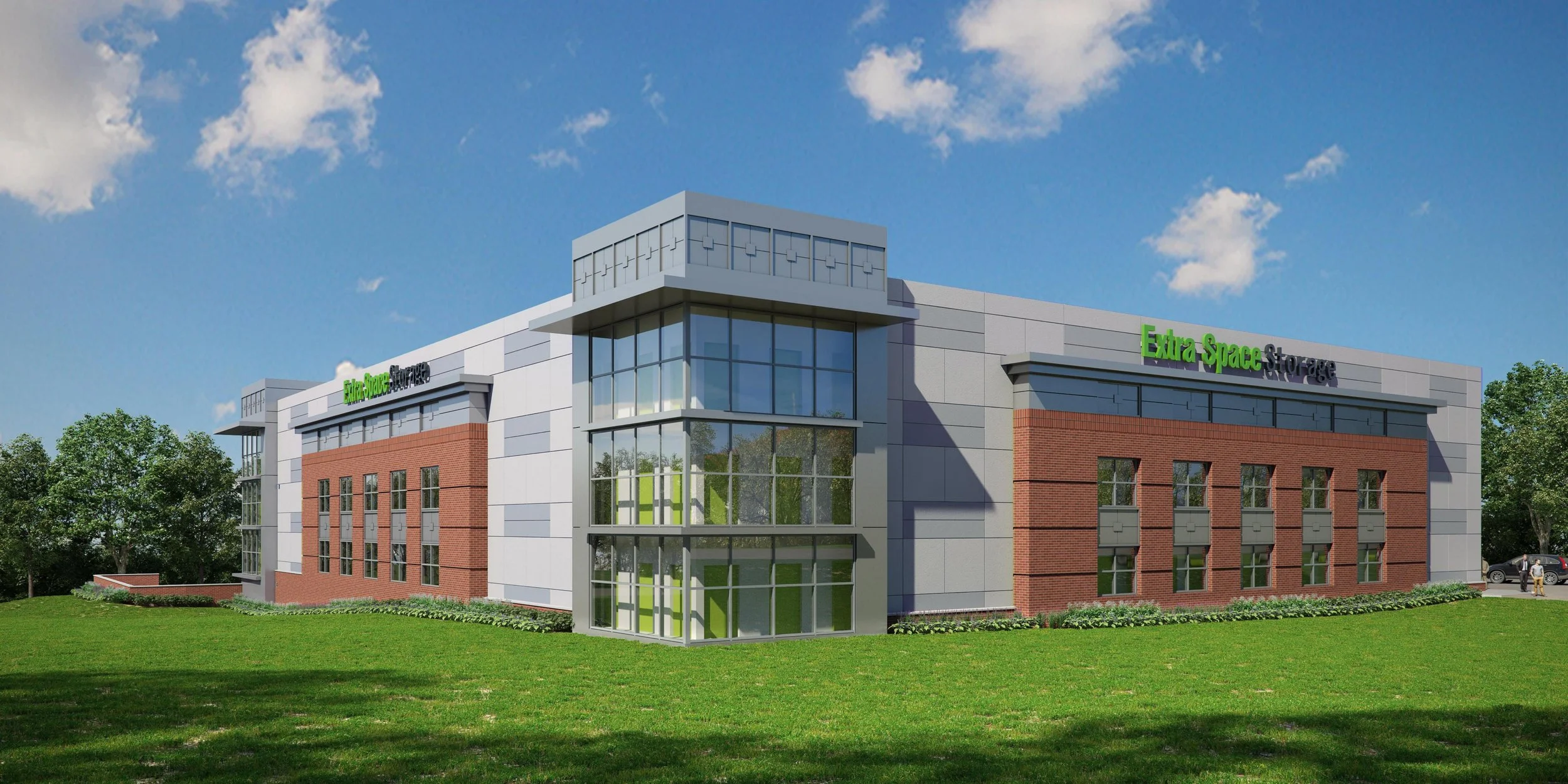 Three story Extra Space Storage self storage facility clad in red brick veneer and grey EIFS within a suburban landscape